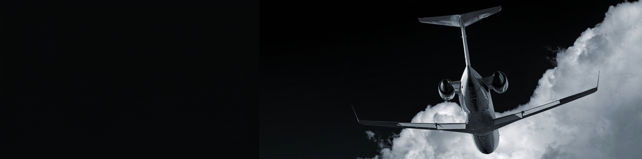 Private jet climbing through cloud, seen from below